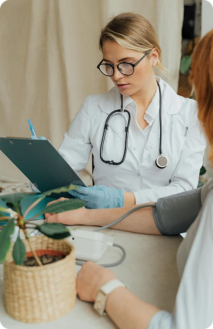 Doctor checking a patient's blood pressure during a consultation
