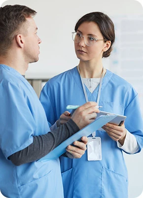 Medical team in scrubs reviewing a patient's treatment plan